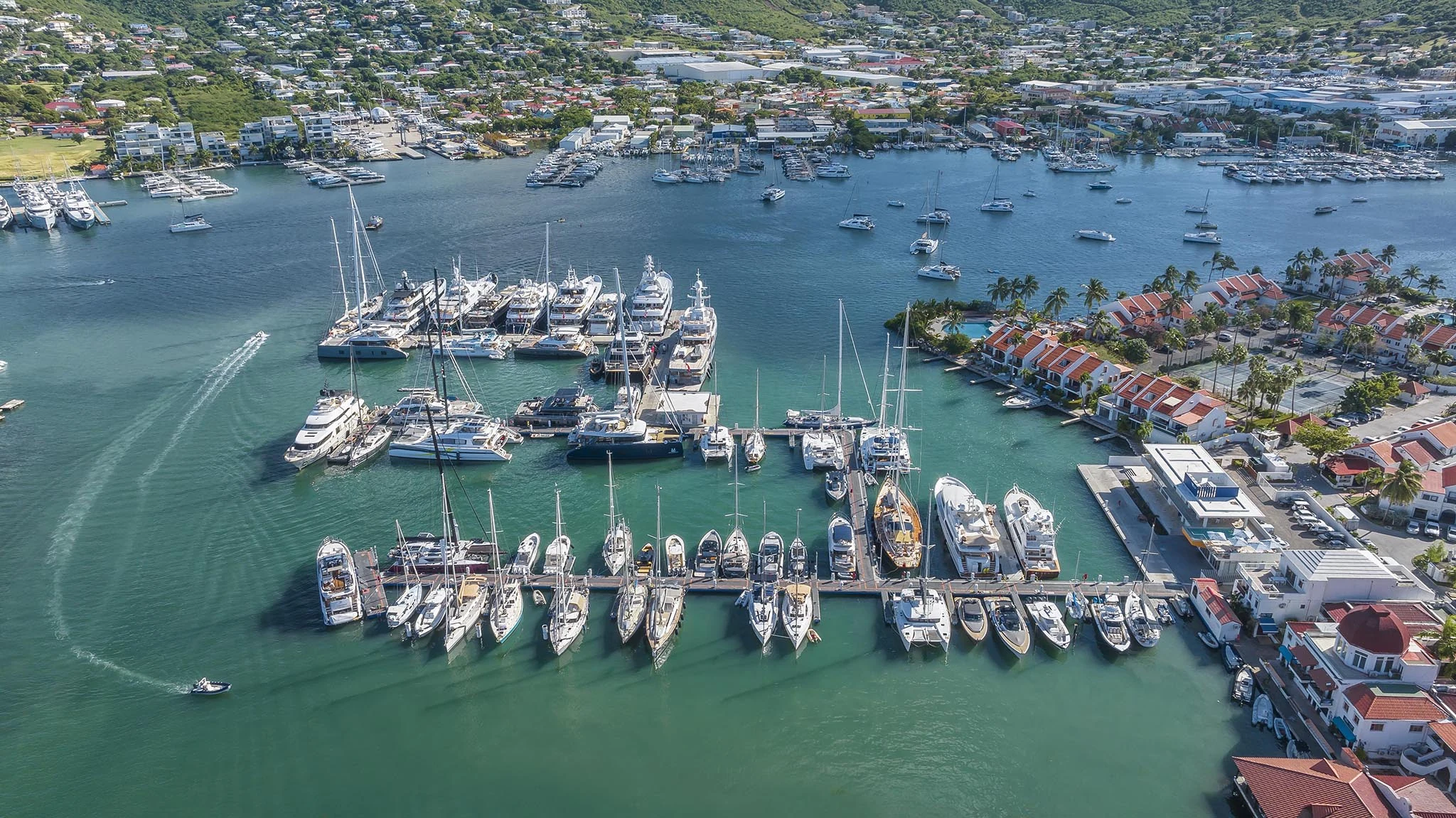 High-resolution aerial view of yachts and marinas across Simpson Bay in Sint Maarten.