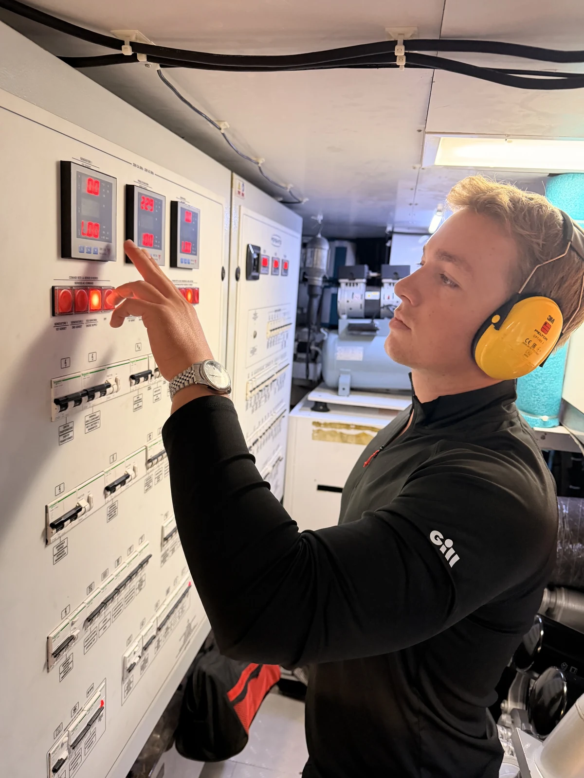 Thomas Boetekees inspecting a yacht's electrical control panel during a maintenance check.