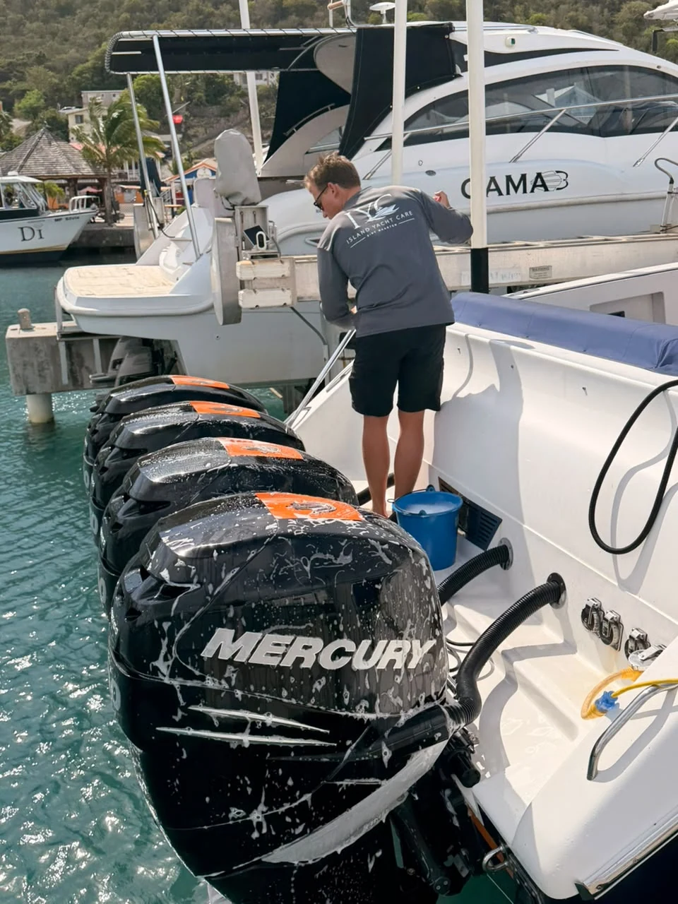 Island Yacht Care washing salt and residue from a yacht's outboard engines in Sint Maarten.